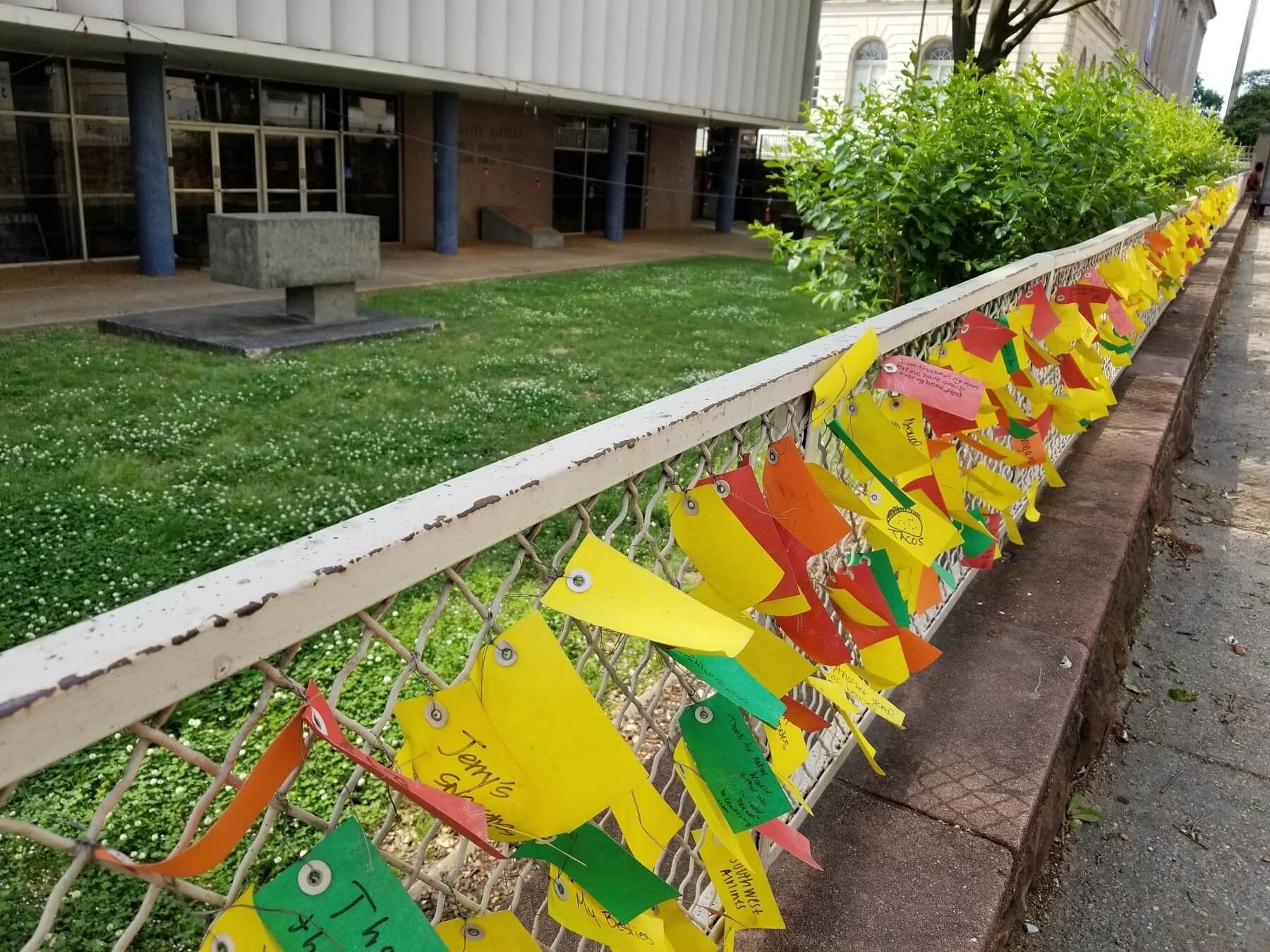 Fence outside of Cossitt Library decorated with gratitude notes.