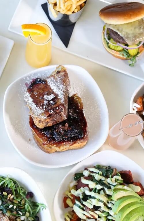 Various brunch dishes like a hamburger and French toast