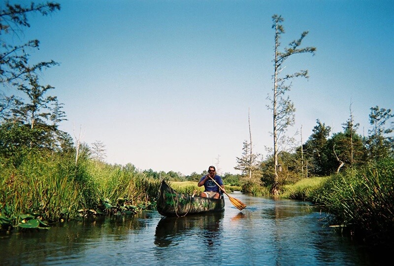 A man canoeing on a river
