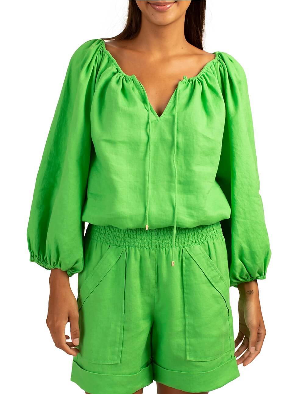 Model in balloon-sleeve green blouse and matching shorts.