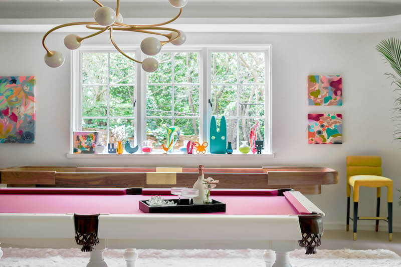 Game Room with pink-felted pool table and colorful art