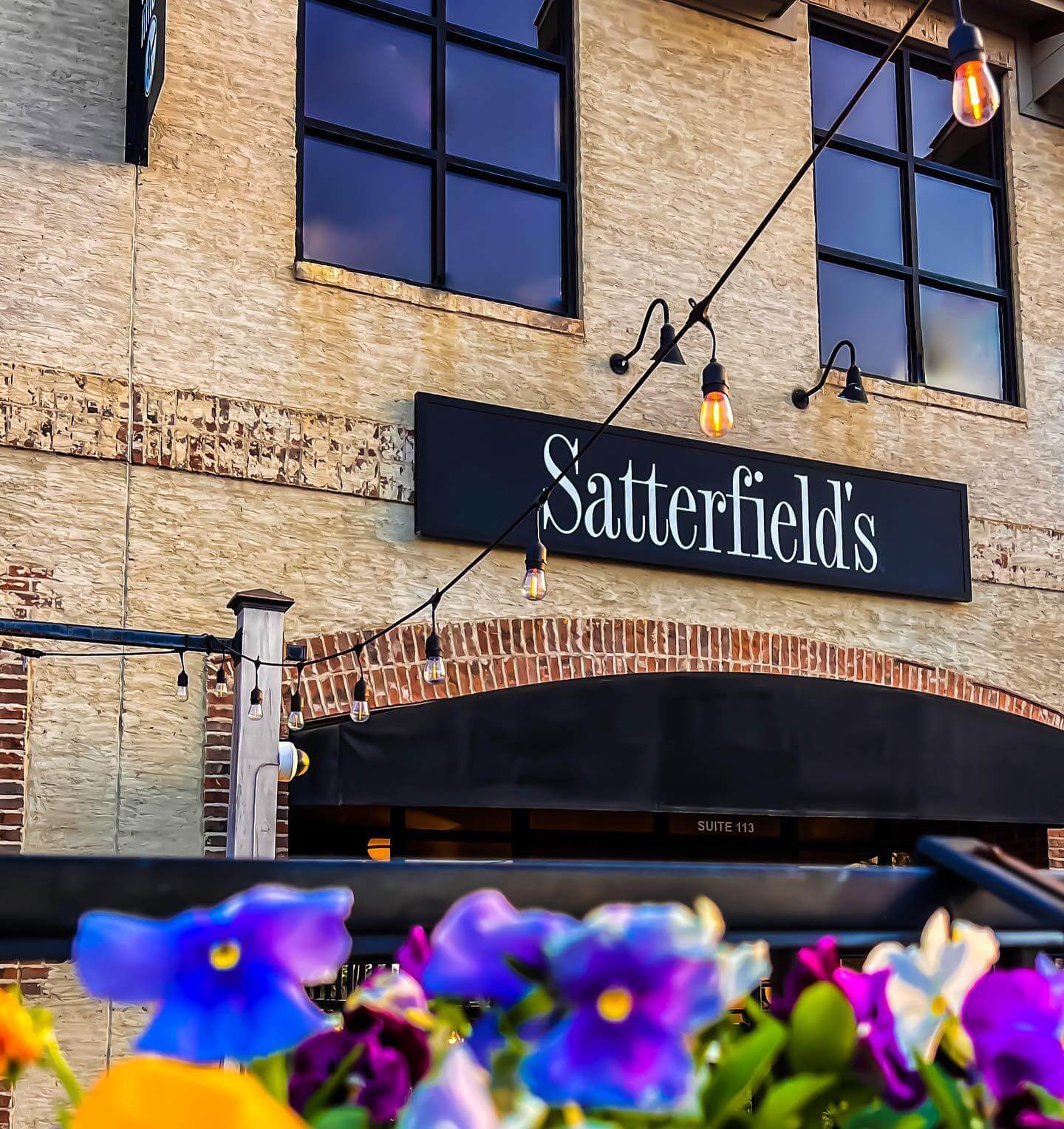 Exterior Satterfield's restaurant with pansies in the foreground