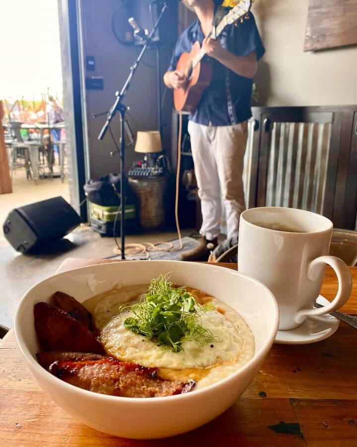 Live guitar musician and grits bowl from The Artisan's Palate