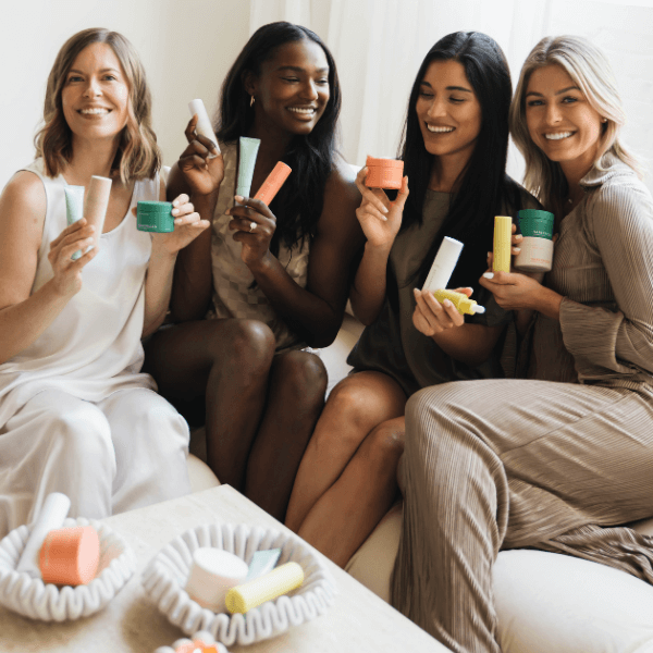 young women posing with skincare products