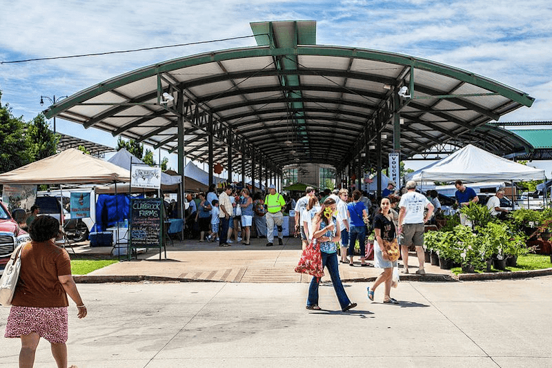 A crowd of people shopping at the Memphis Farmers' Market